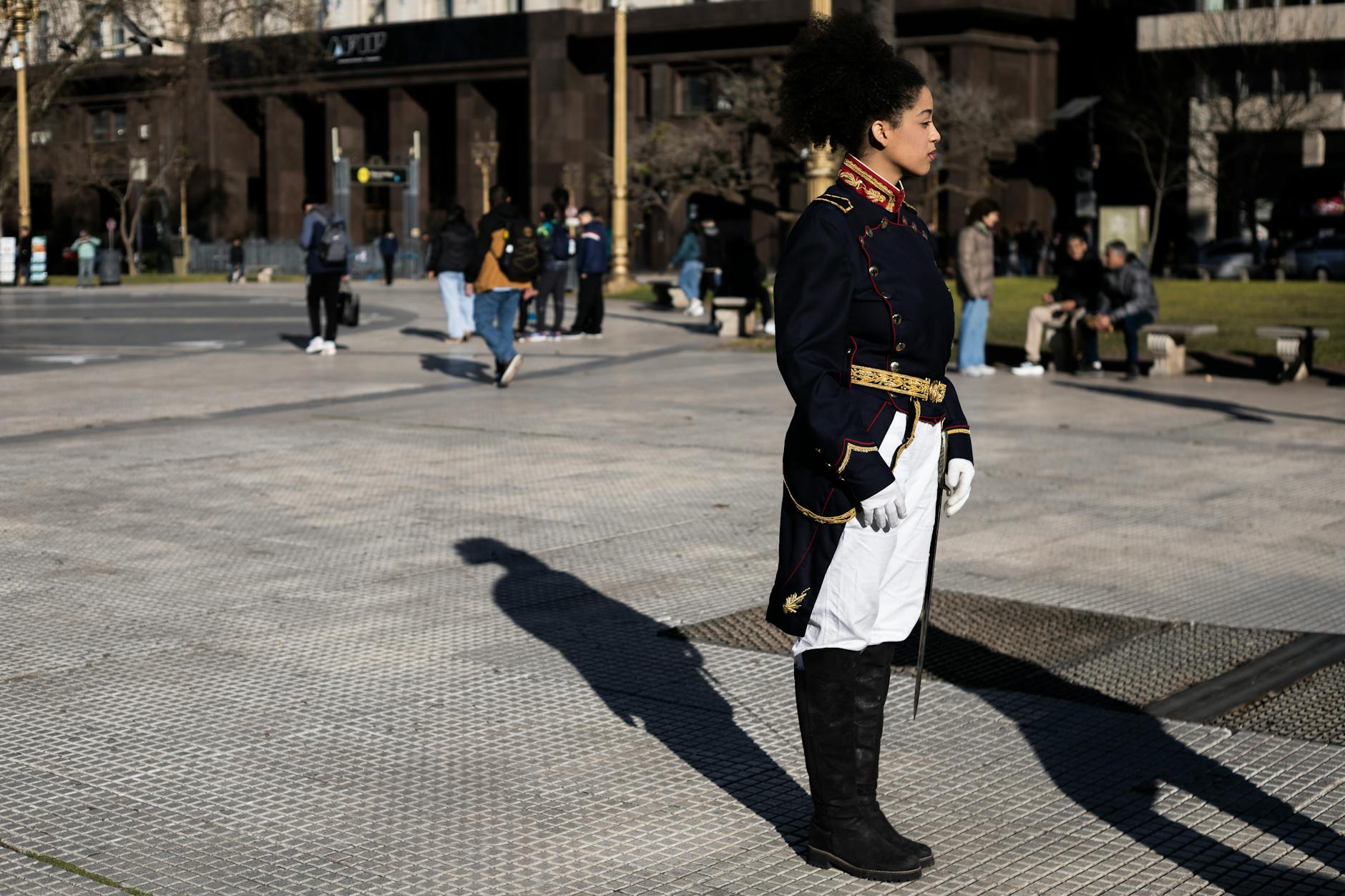 A person in a ceremonial uniform stands in a plaza in Buenos Aires, Argentina.