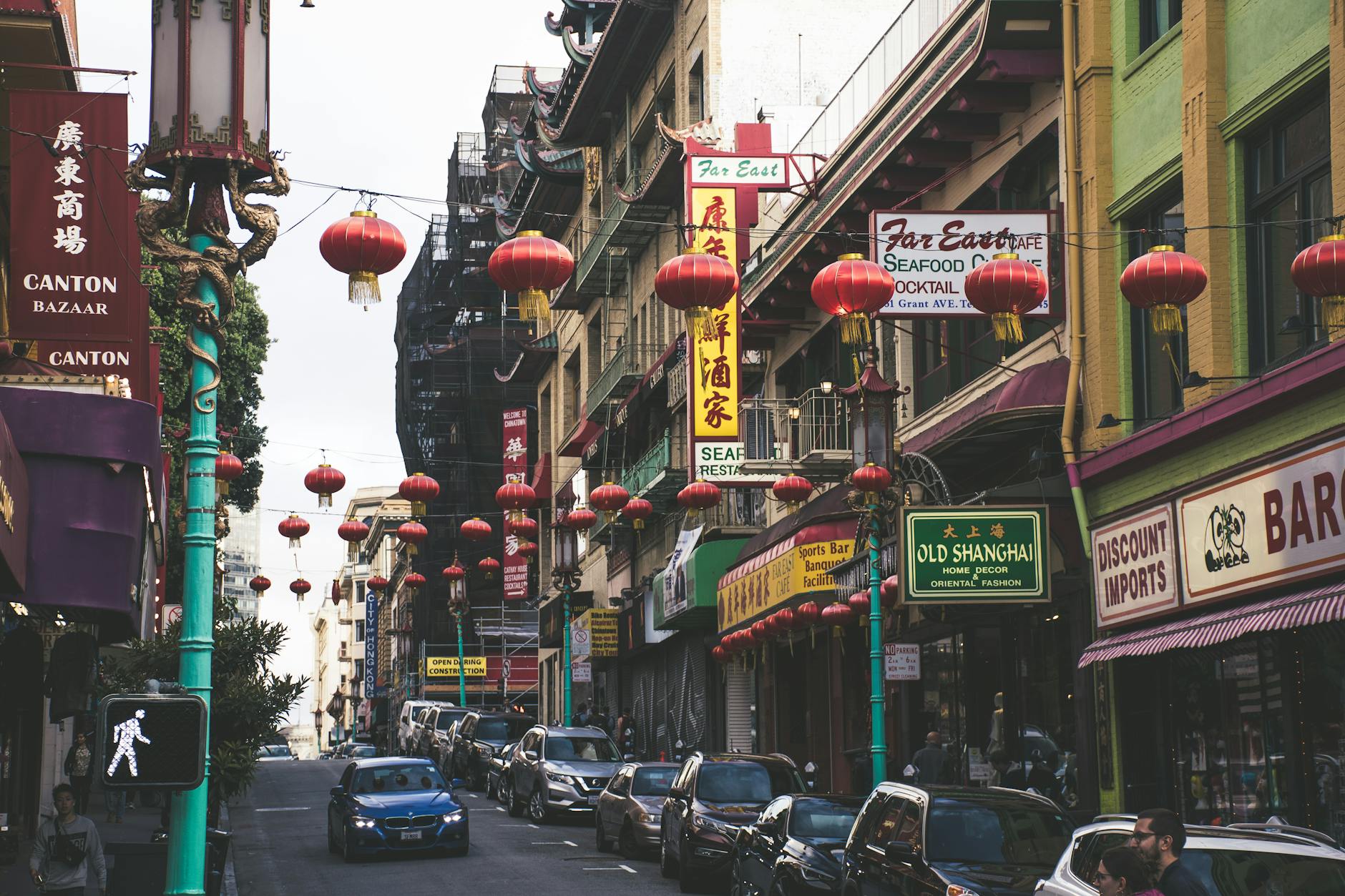 Bustling San Francisco Chinatown street with red lanterns and shops, capturing urban vibrancy.