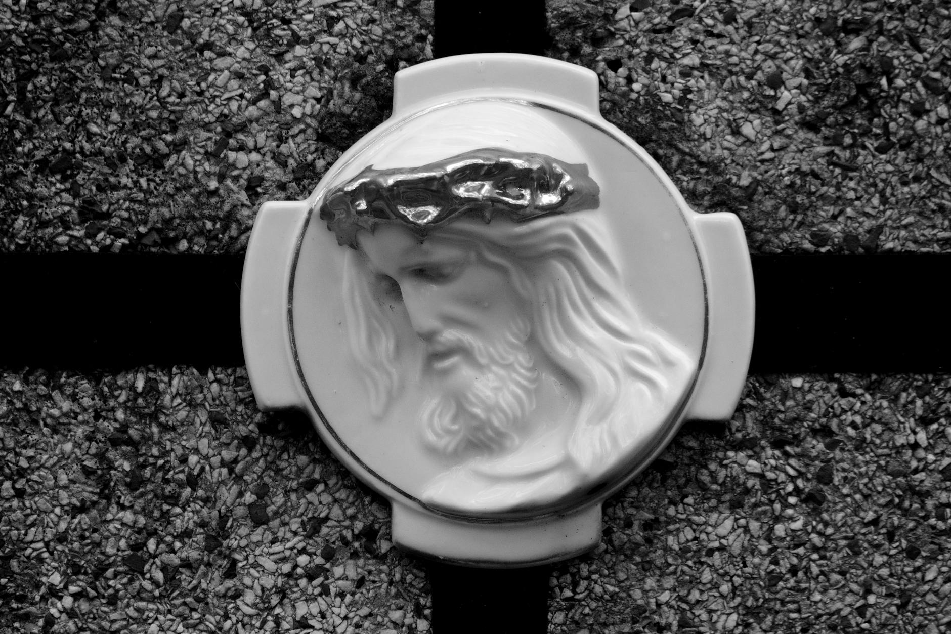 Monochrome bas-relief of Jesus with a crown of thorns, symbolizing faith.