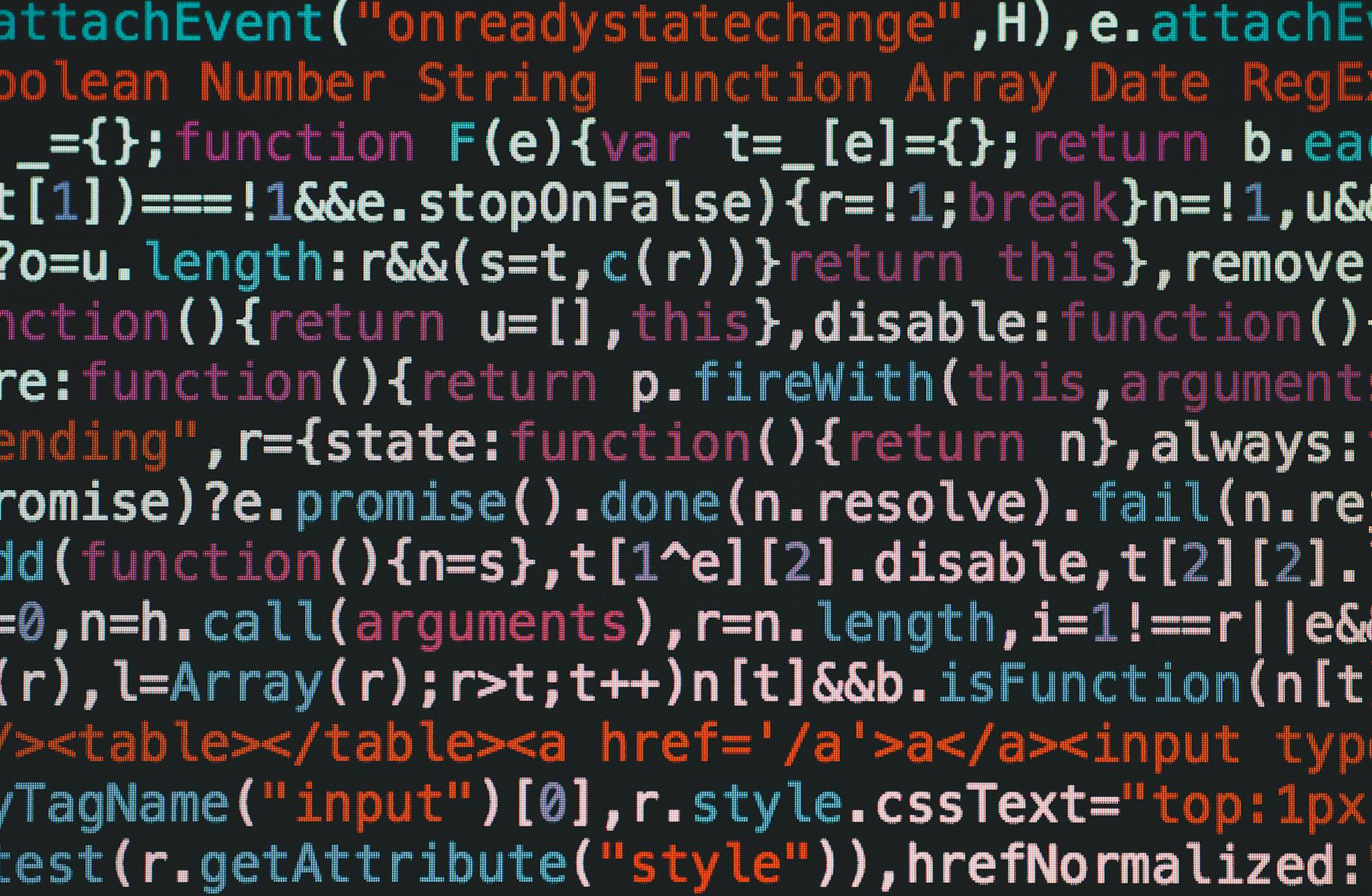 Close-up of colorful coding text on a dark computer screen, representing software development.