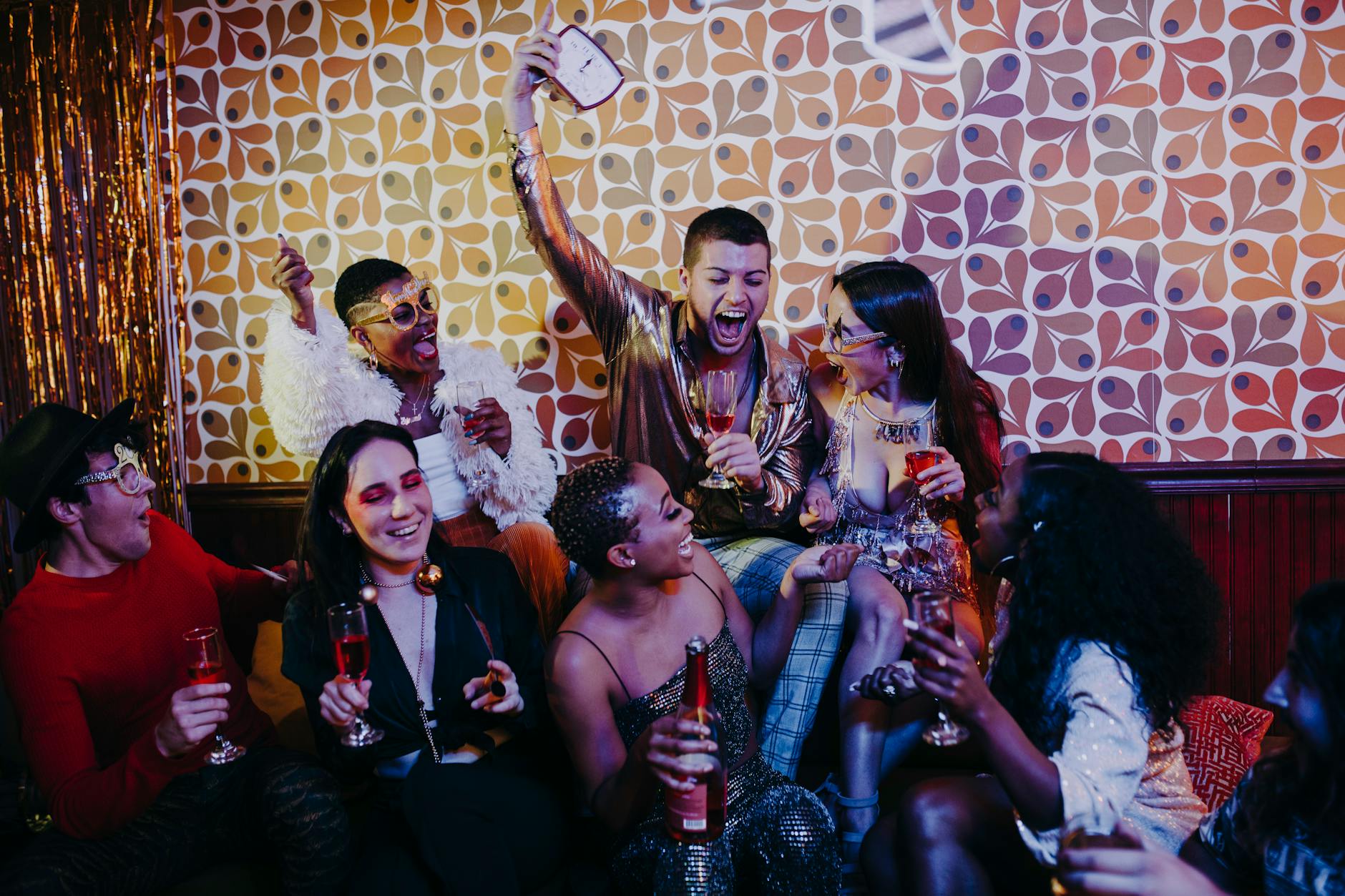 Group of diverse friends enjoying a lively indoor retro-themed celebration.