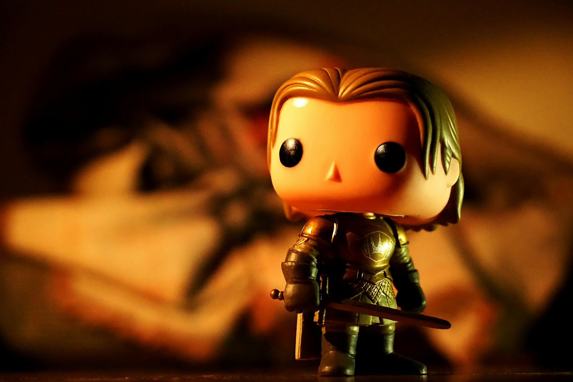 A cute toy figure in armor with dramatic light and warm tones, perfect for creative projects.