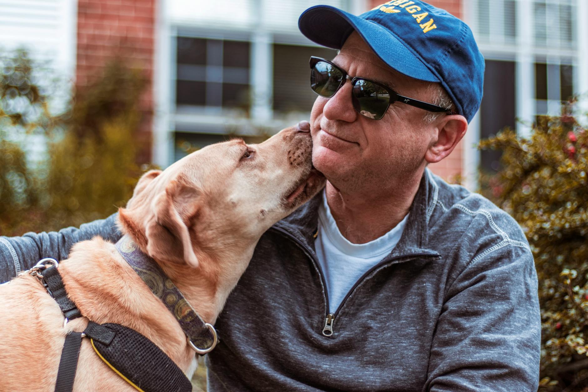 Man and his dog share a loving moment outdoors, showcasing friendship and joy.