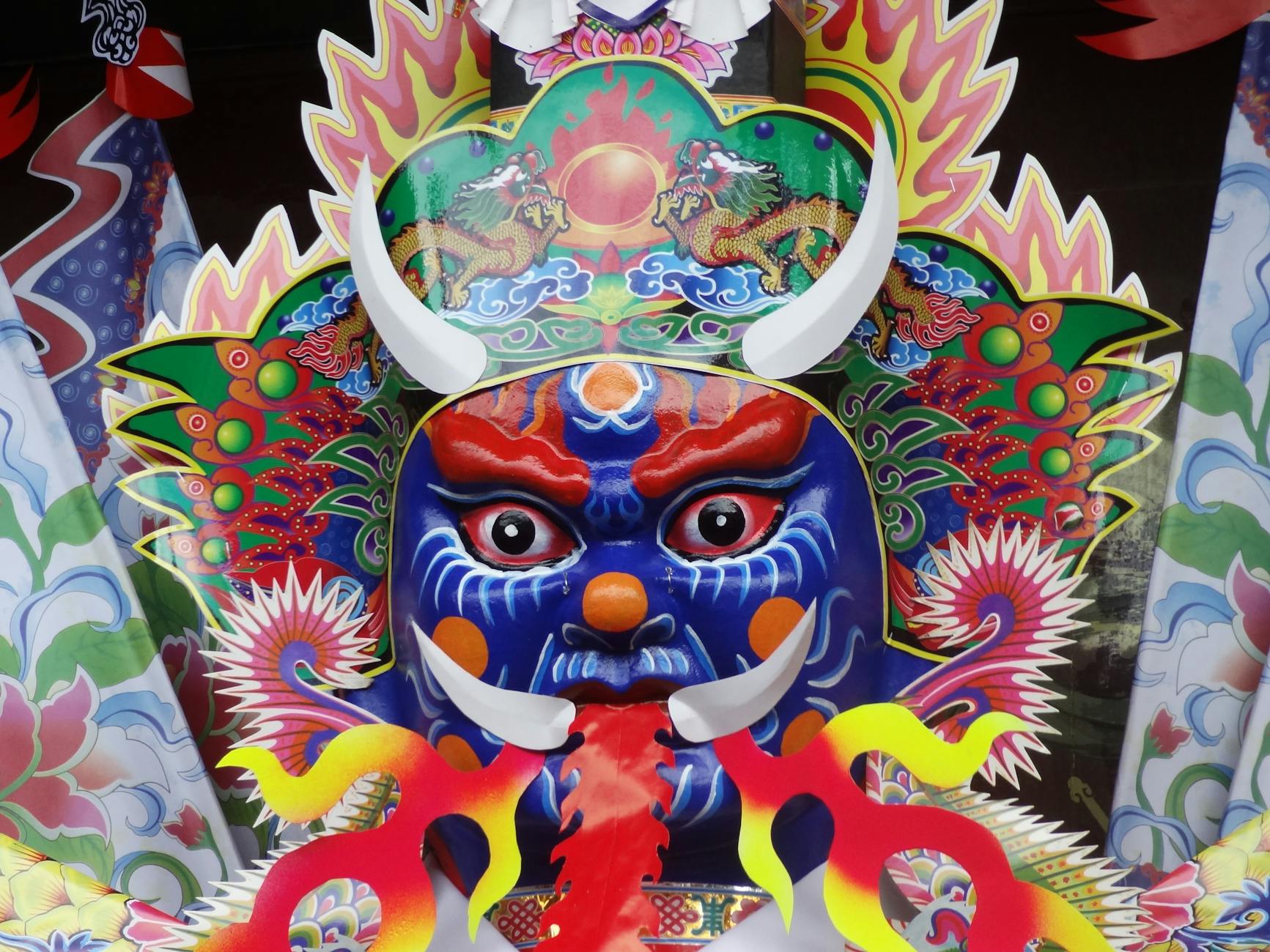 Colorful and intricate Asian mask art, showcasing vibrant cultural symbolism and detailed craftsmanship.