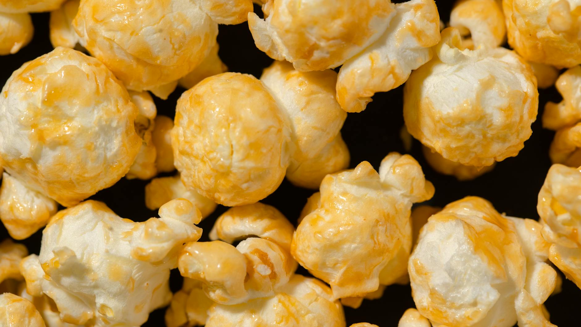 A tempting close-up of buttery popcorn, showcasing its texture and golden color.