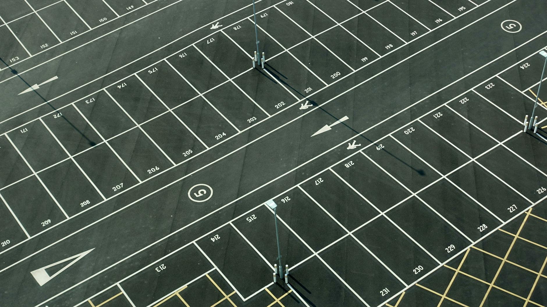 Aerial view of an empty parking lot with numbered spaces in London.