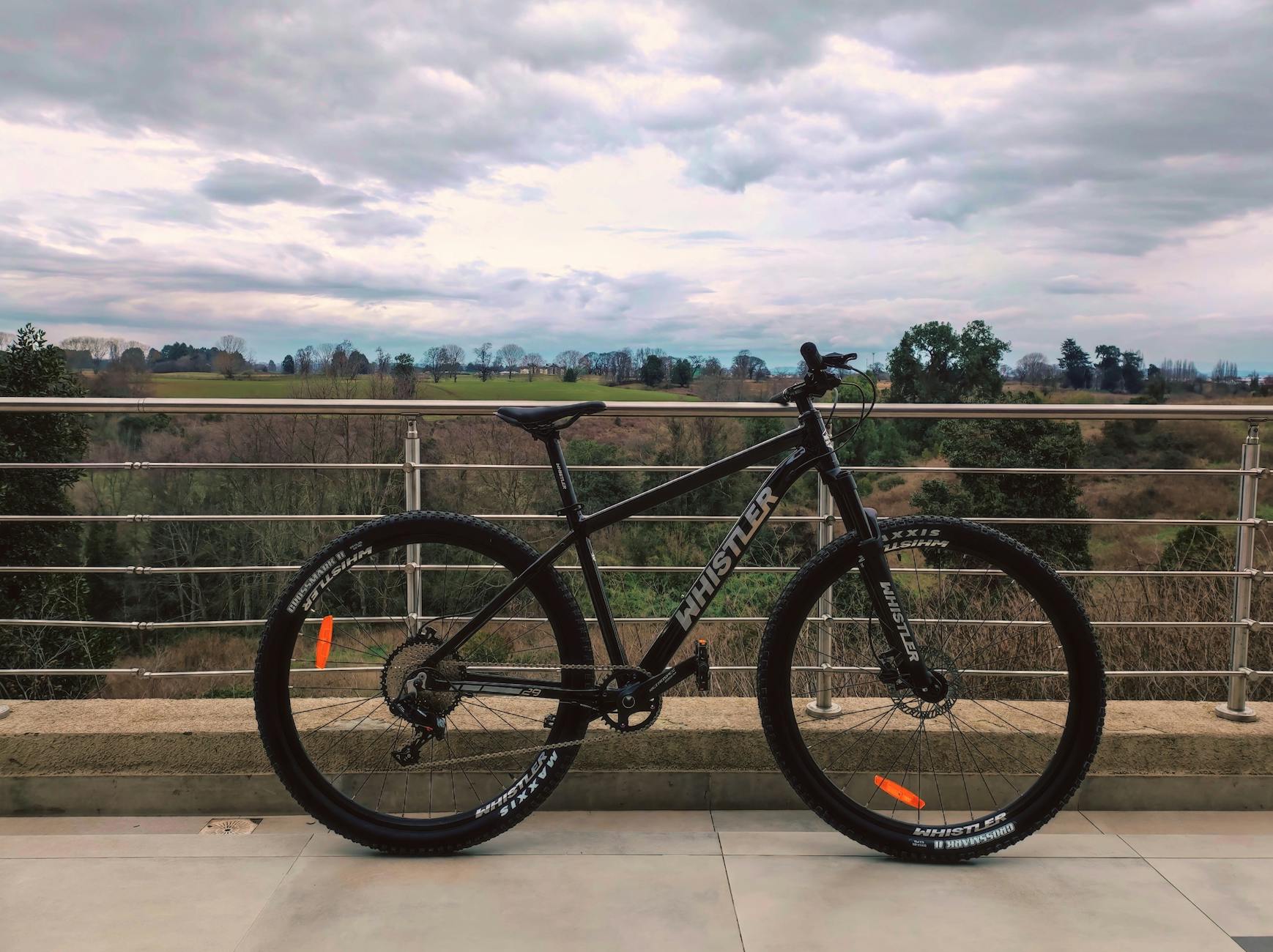 Mountain bike on balcony overlooking scenic landscape in Osorno, Chile.