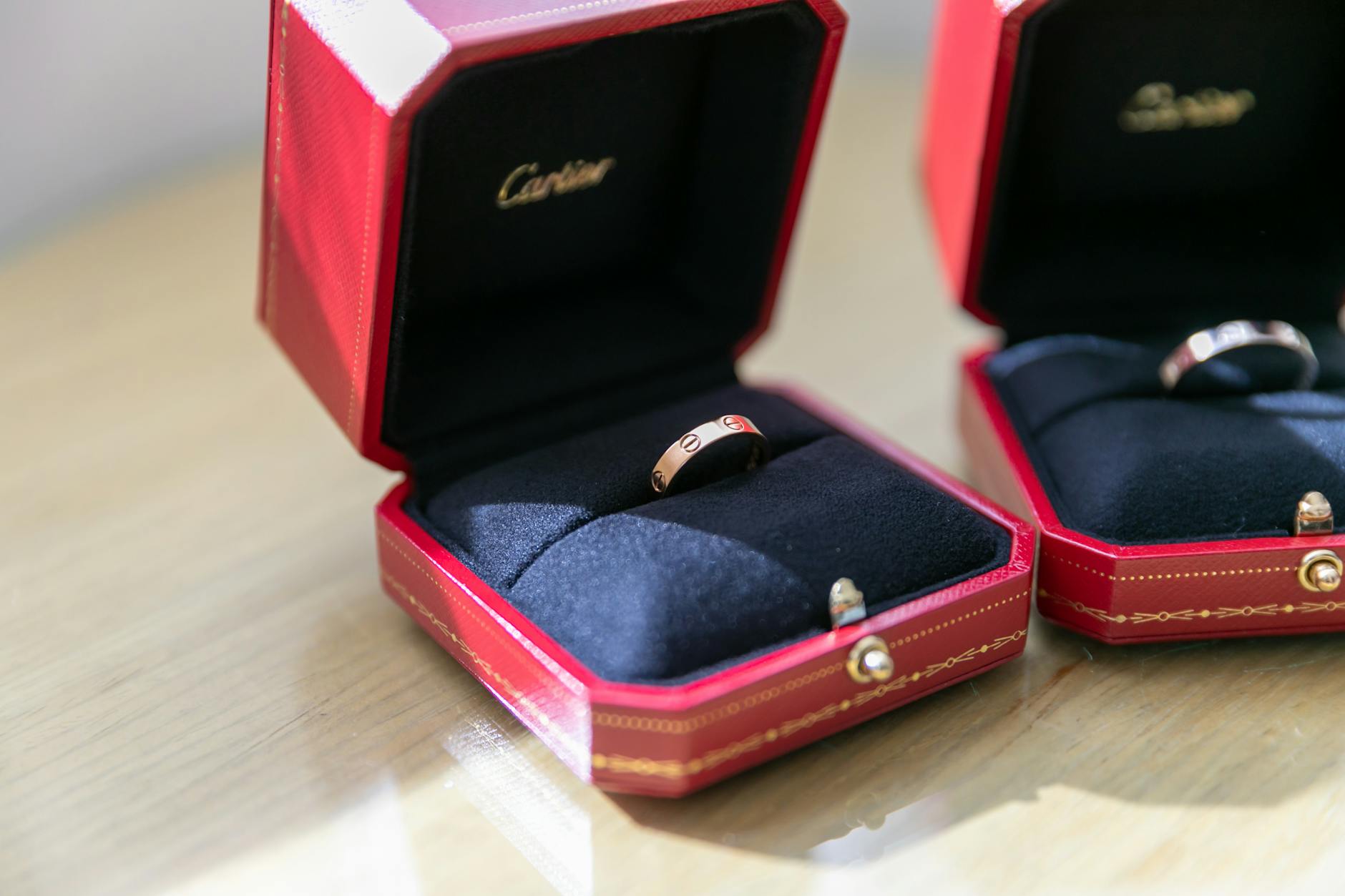 Luxurious Cartier rings displayed in exquisite red boxes, perfect for a premium gift or engagement.