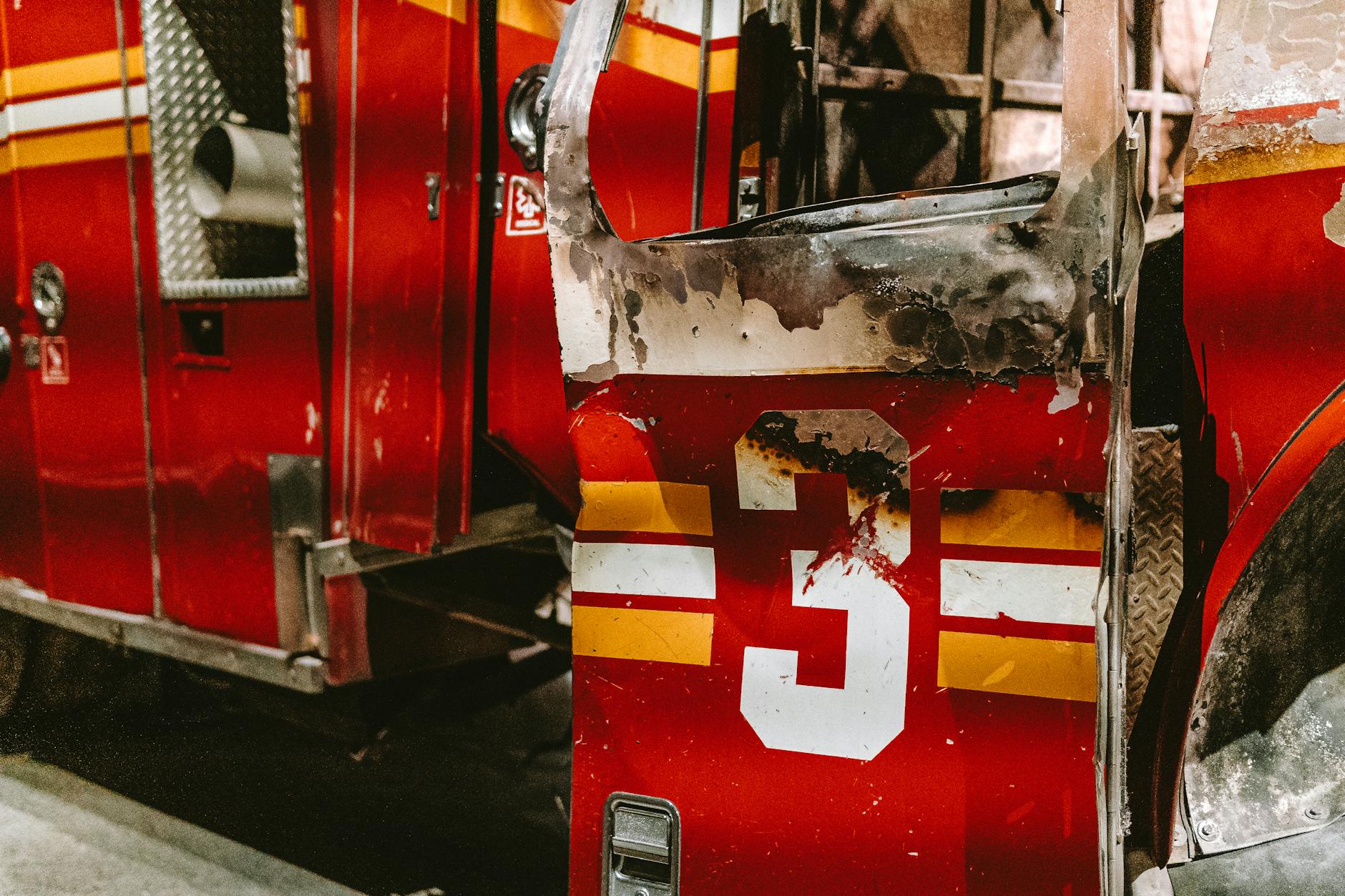 Close-up of a burned fire truck door with the number three in NYC.
