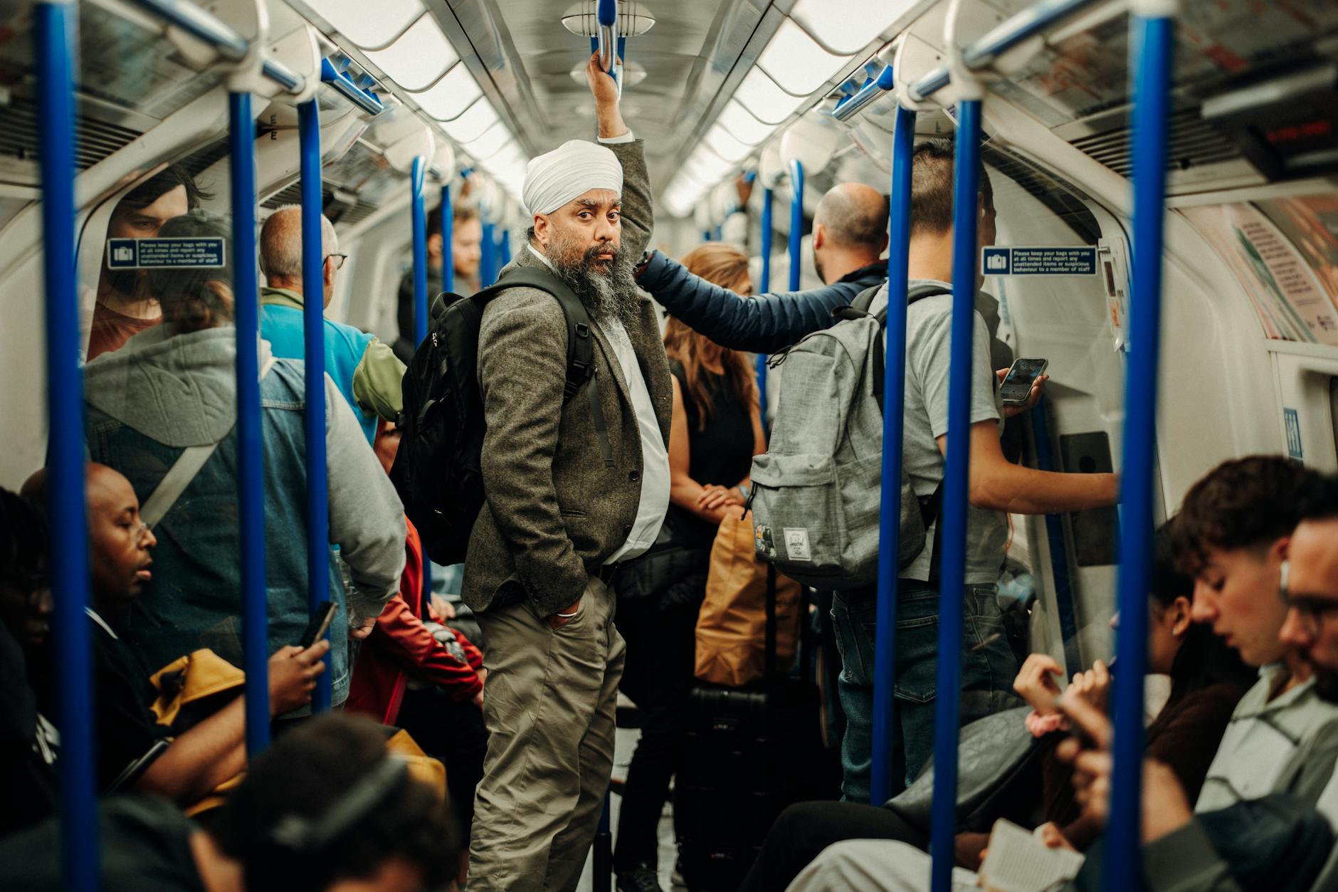 A busy scene of people traveling on London's iconic Underground subway train.
