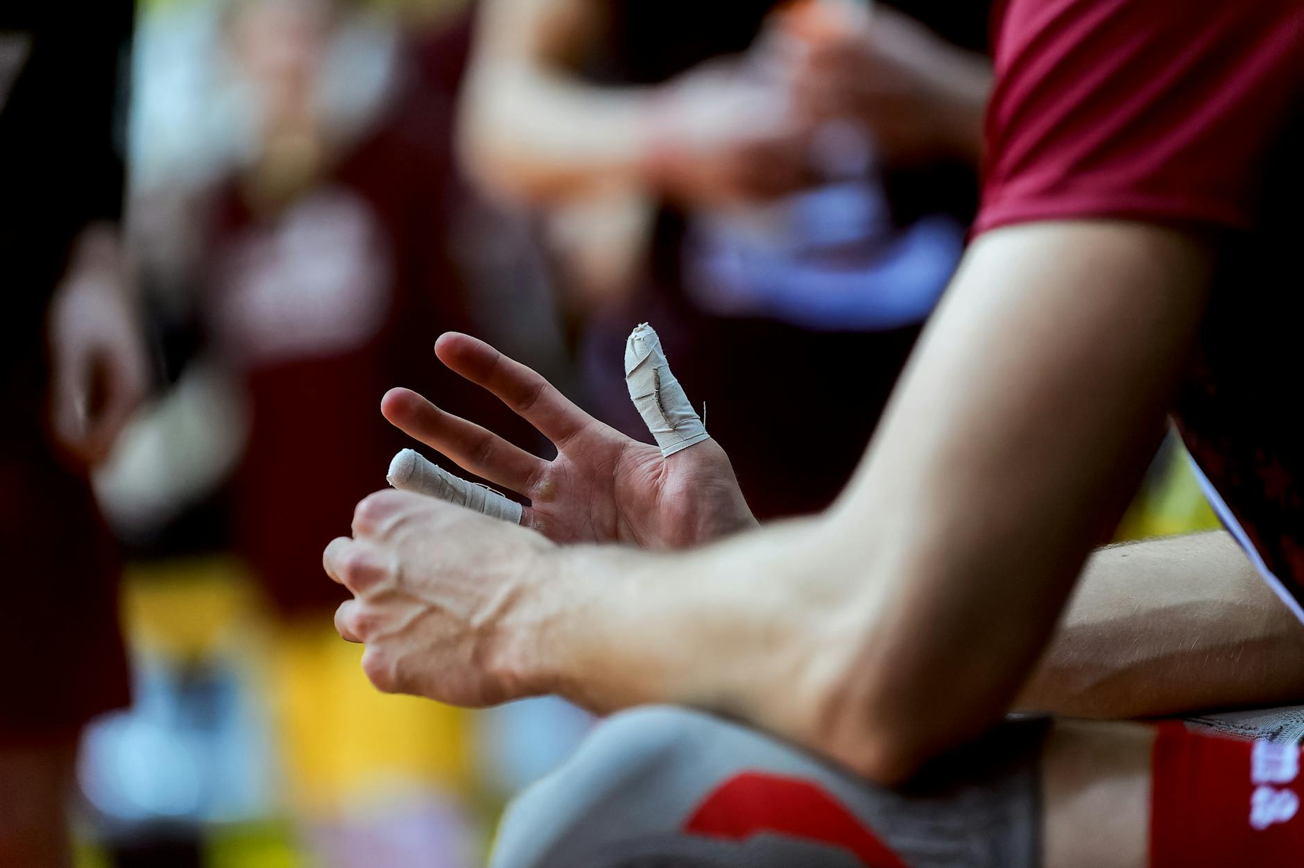 A focused view of an athlete's taped hands during a break from training. Sport and endurance.