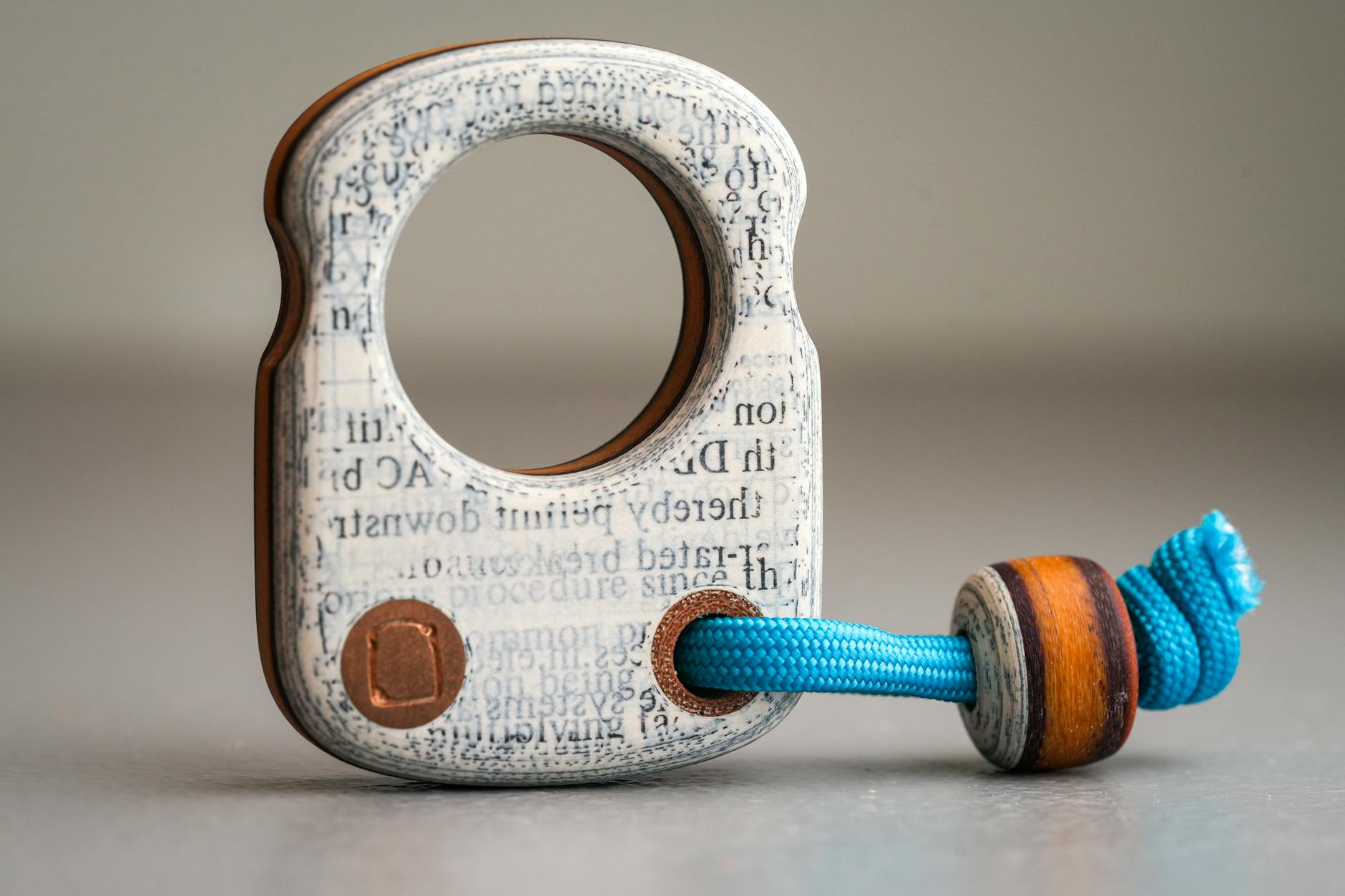 Close-up of an artistic wooden and rope toy with typewriter-style design.