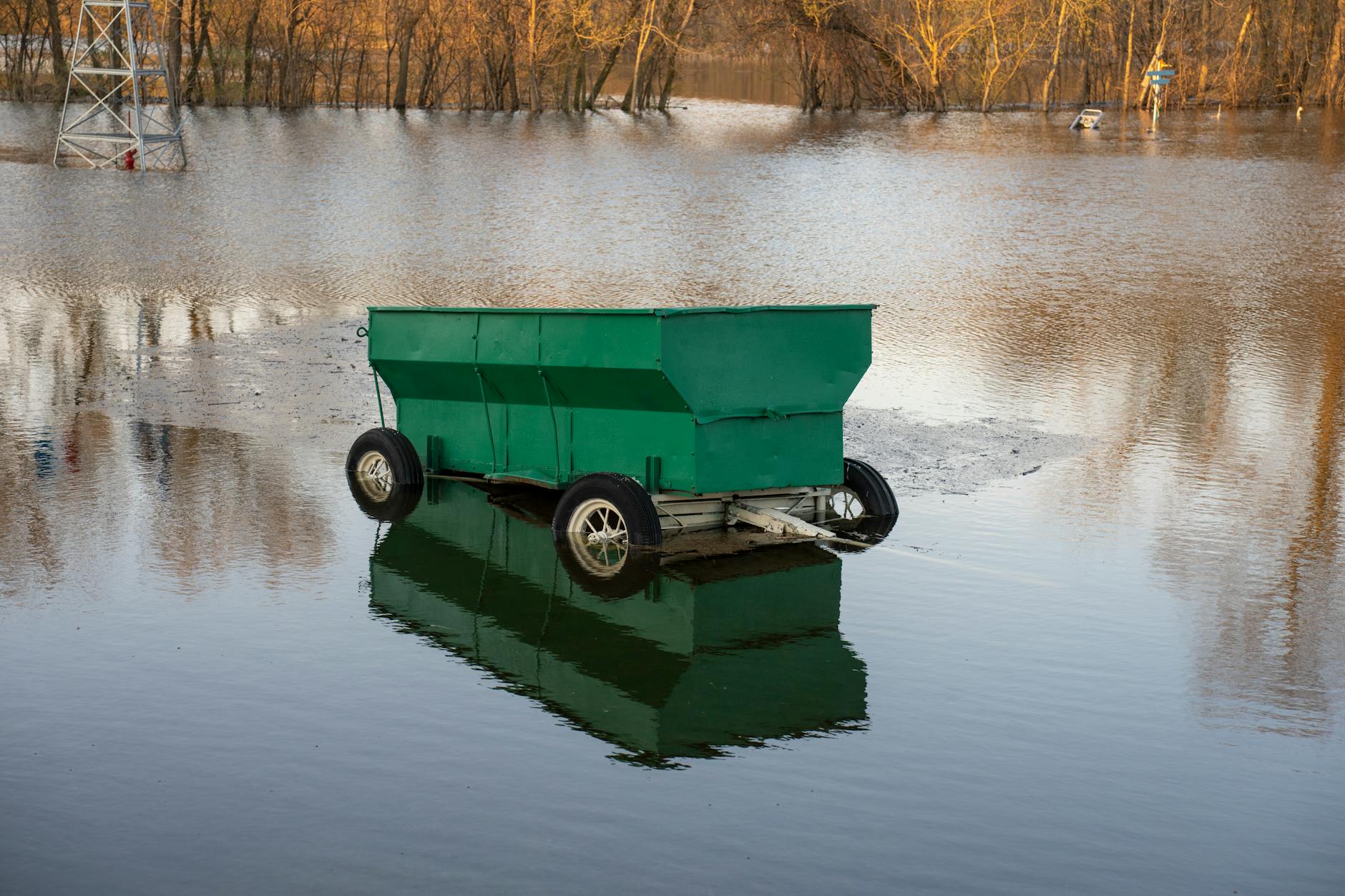 Flooded area with green trailer submerged in Wabasha, MN, USA.
