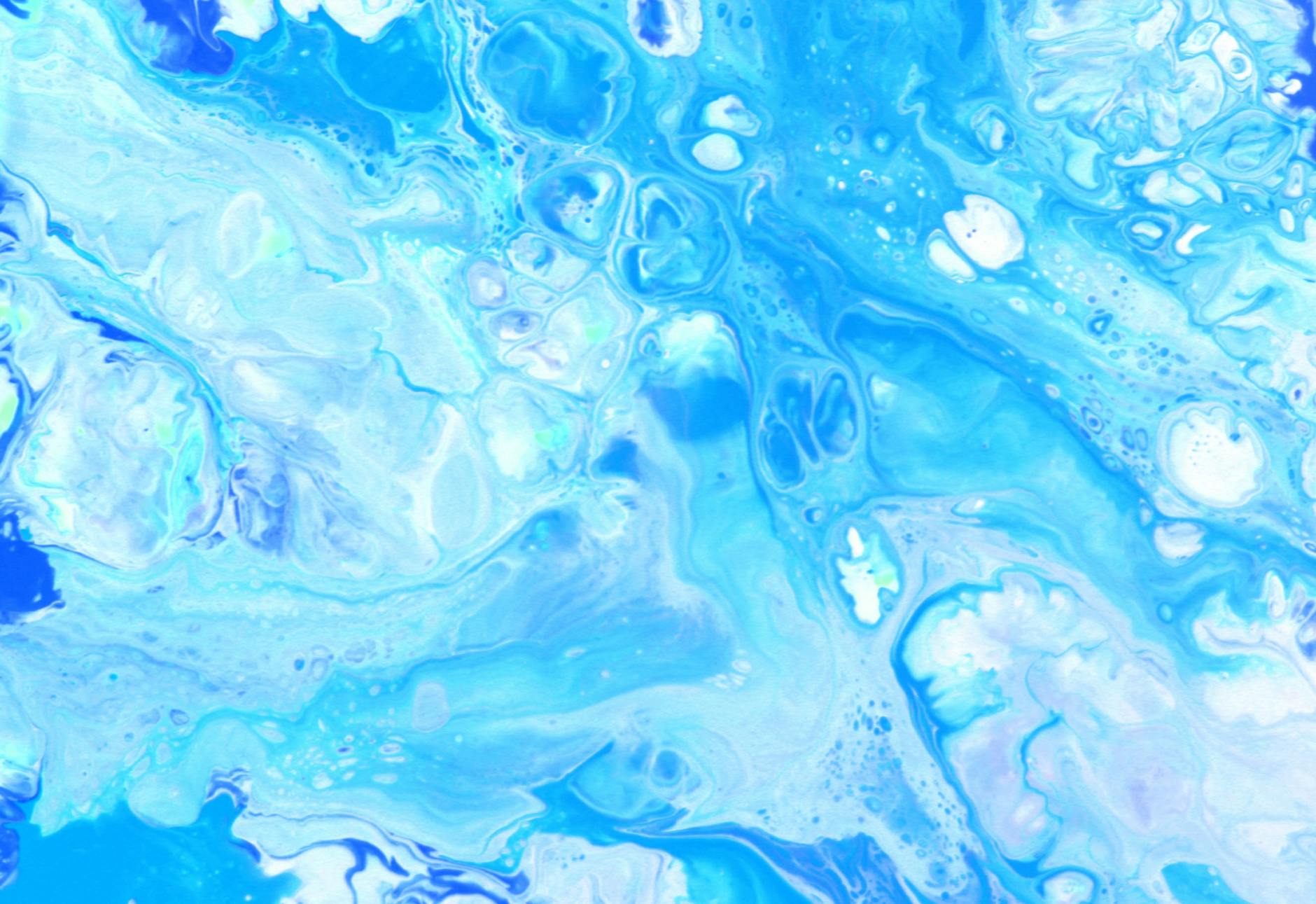 A mesmerizing abstract image of blue and white marble patterns resembling ocean waves.