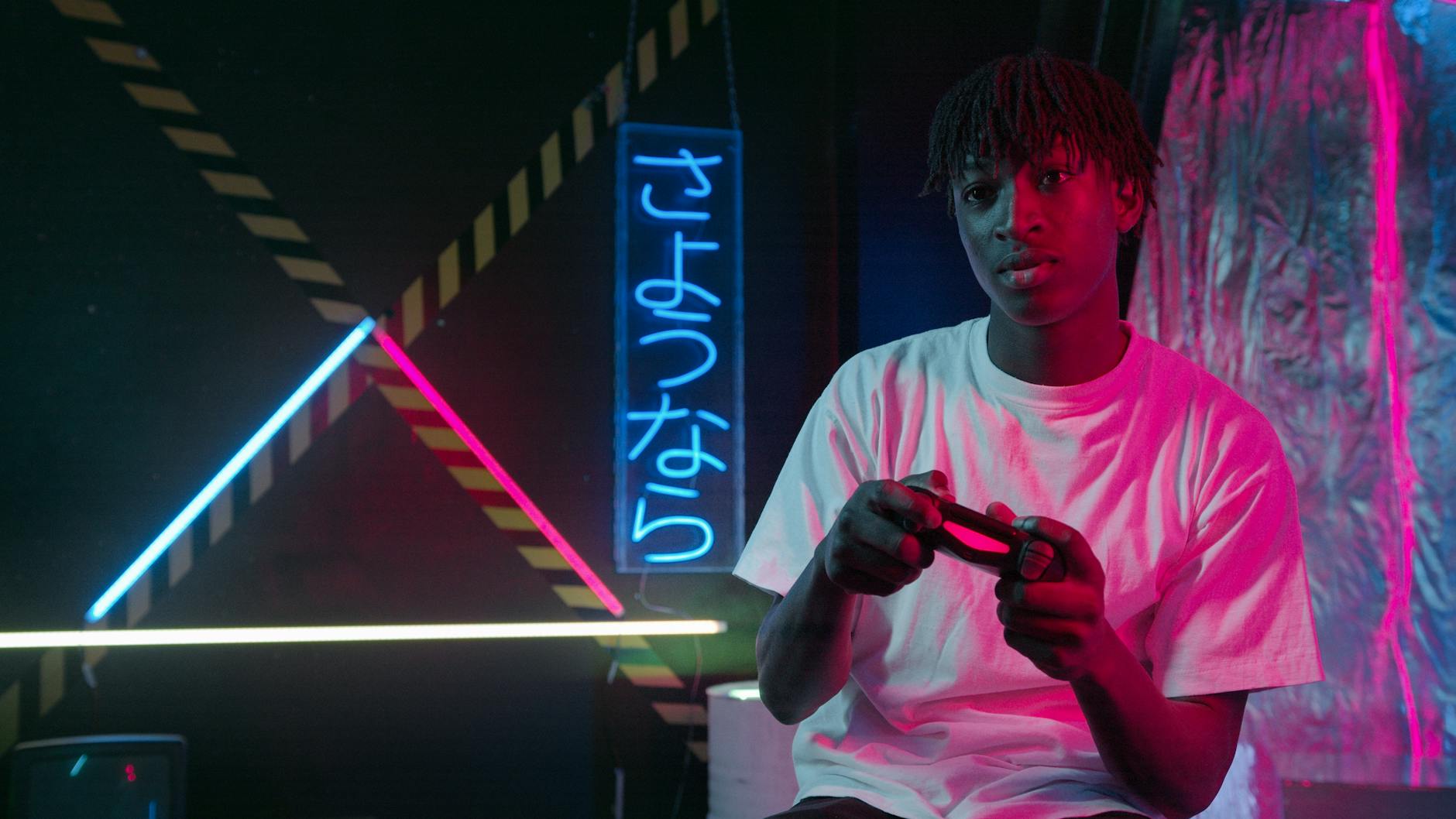 Teenager with a game controller in a neon-lit room with Japanese kanji and vibrant colors.