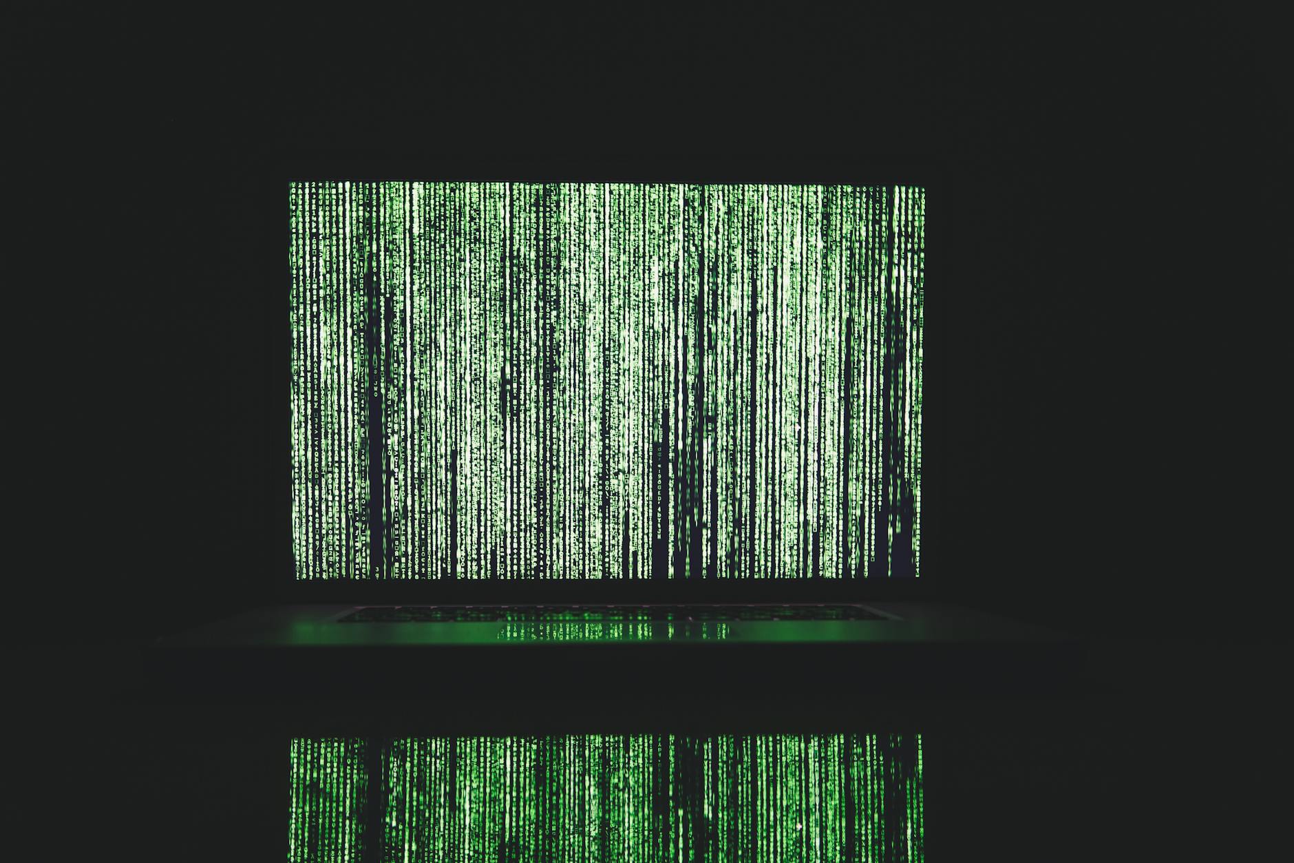 Abstract depiction of green matrix code on a computer monitor.