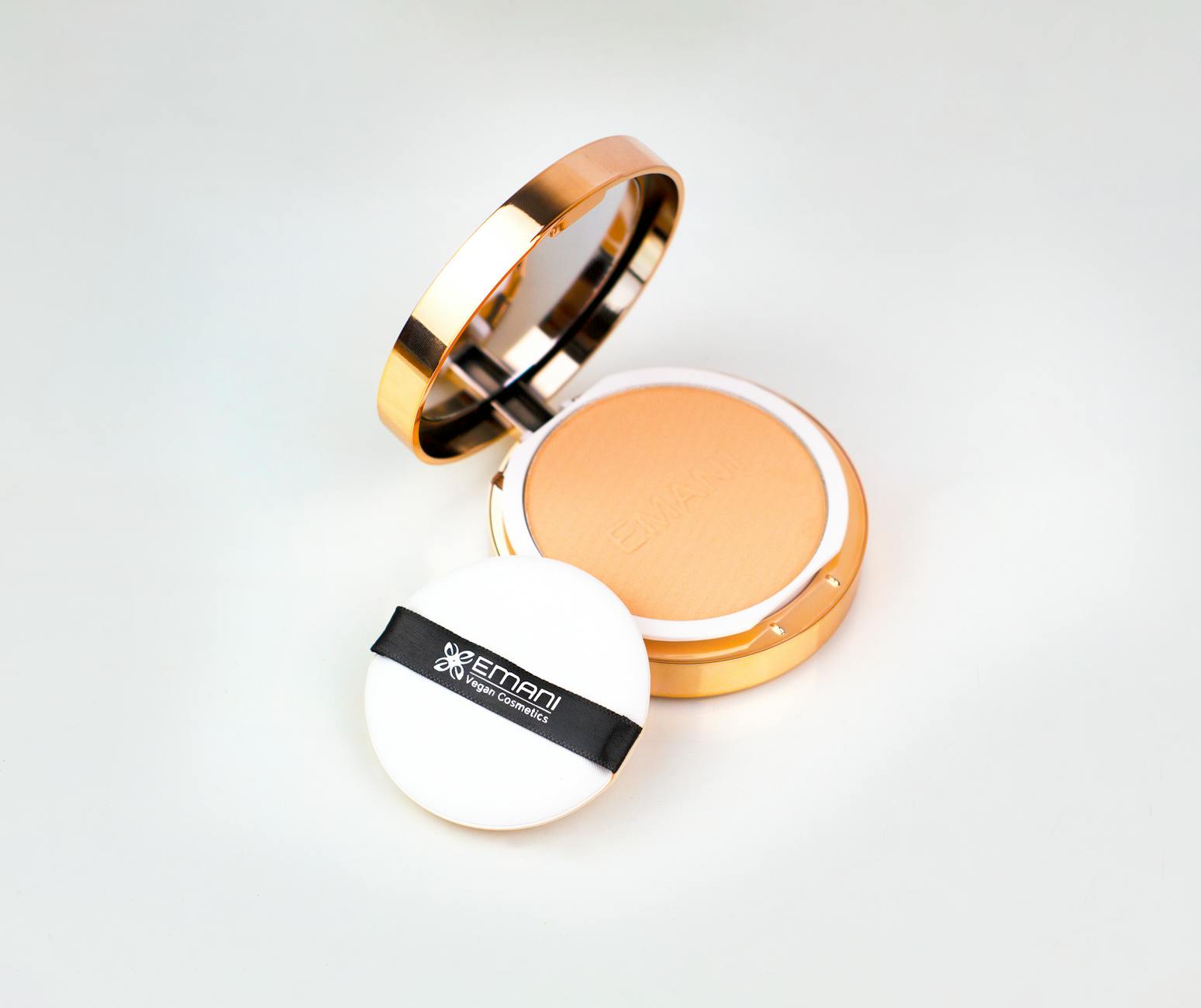 High-quality vegan compact powder with puff and mirror in elegant packaging.