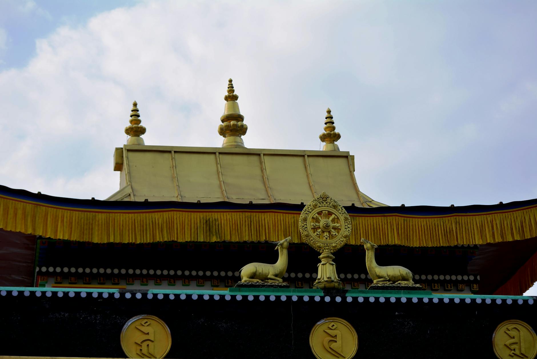 A view of ornate Buddhist architectural elements at a temple in Gangtok, Sikkim, India.