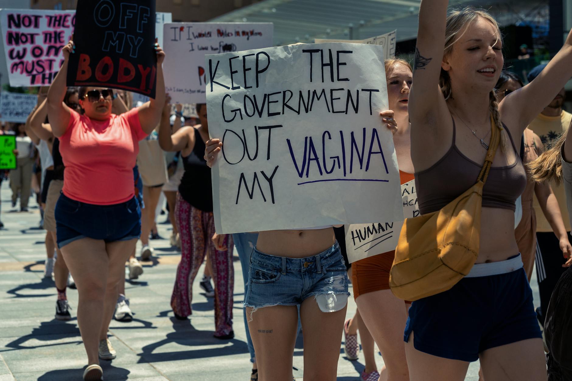 A vibrant protest advocating for women's rights with bold placards and passionate individuals.