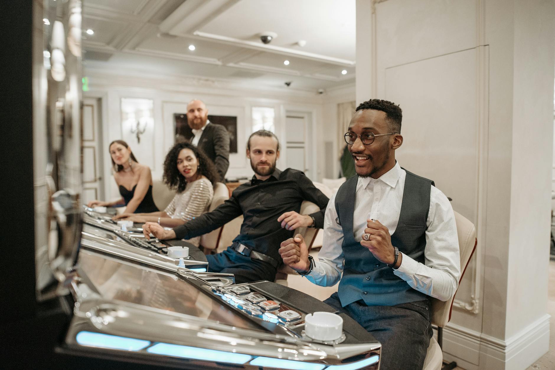 Diverse group of adults enjoying a vibrant casino atmosphere with slot machines.