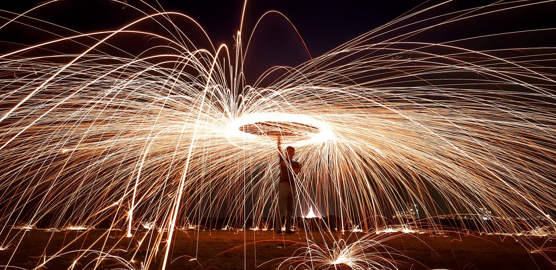 Dynamic steel wool photography captured at night, featuring light trails in Mumbai.