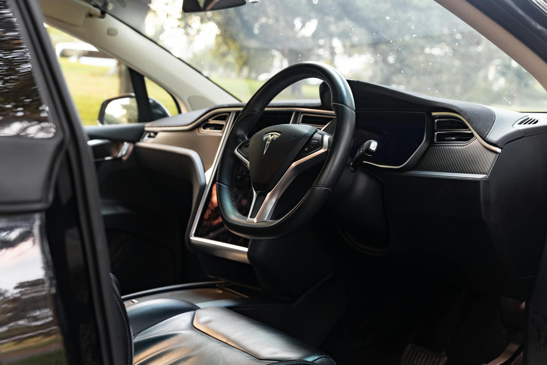 Explore the elegant interior of a Tesla Model X captured in a Sydney park setting.