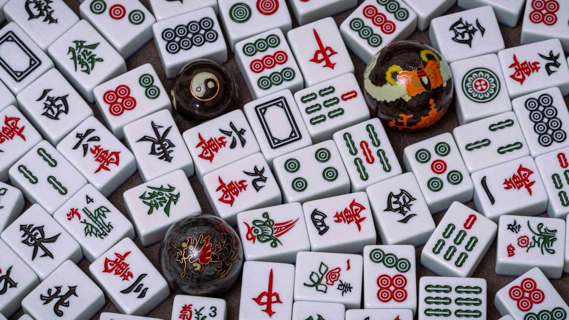 Close-up of traditional Mahjong tiles with Baoding balls, showcasing intricate Chinese symbols and patterns.