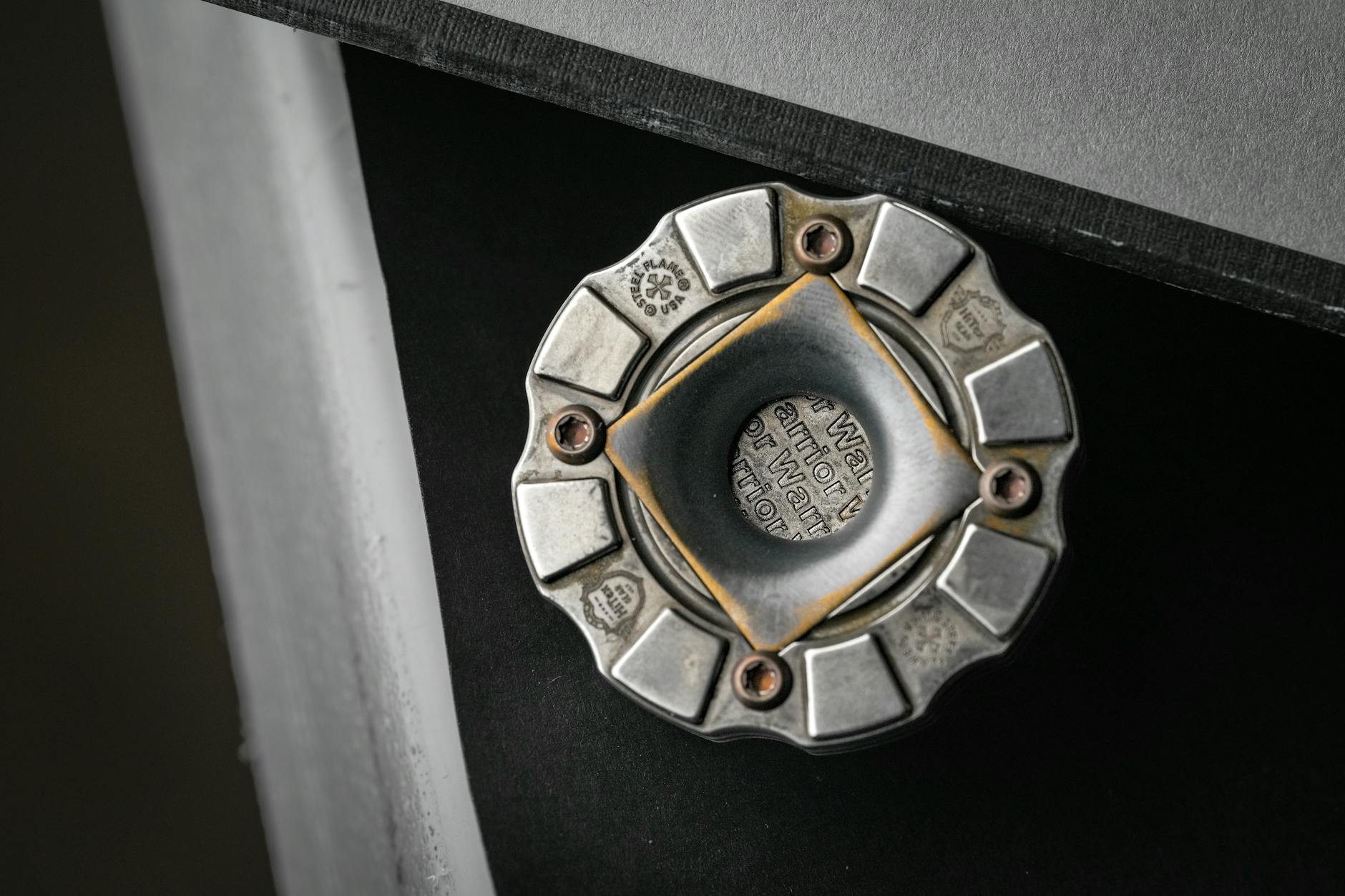 Detailed view of a metallic valve with engraved text, showing intricate design and industrial use.