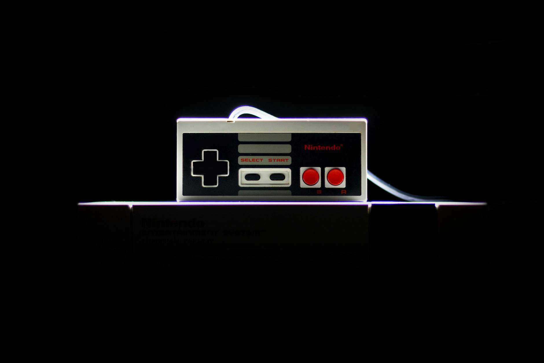 A close-up of a classic NES controller with dramatic lighting on a black background, evoking nostalgia.