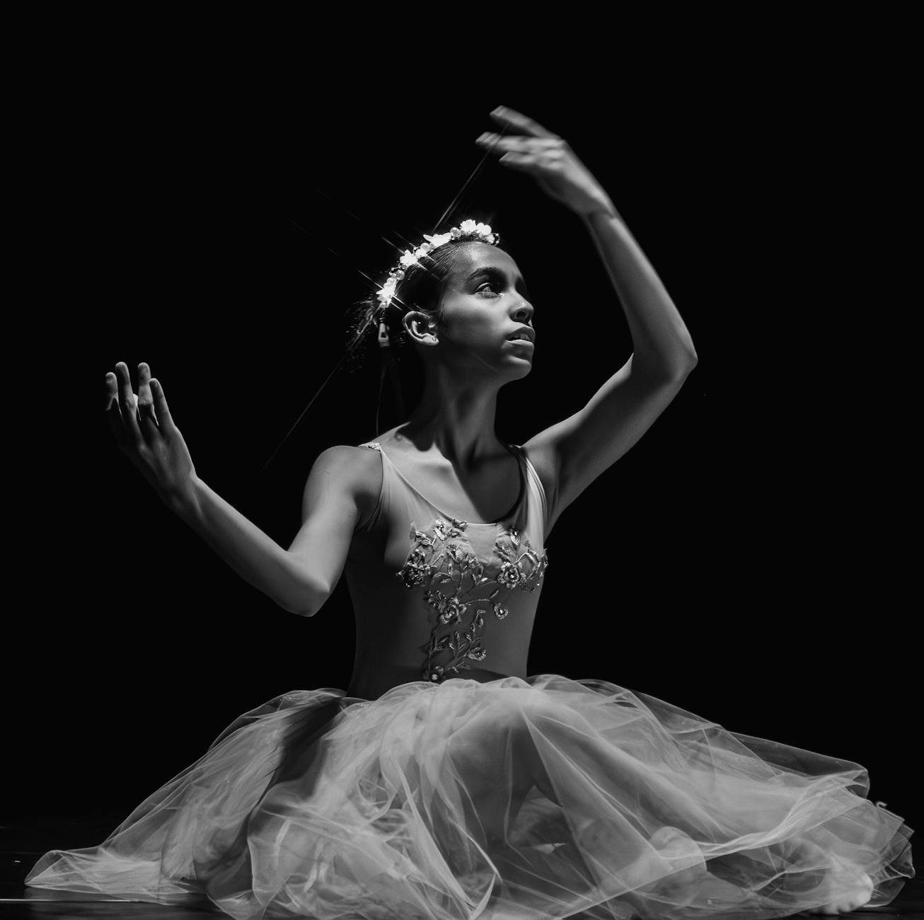 A graceful ballerina captured in dramatic black and white, showcasing the beauty of ballet.