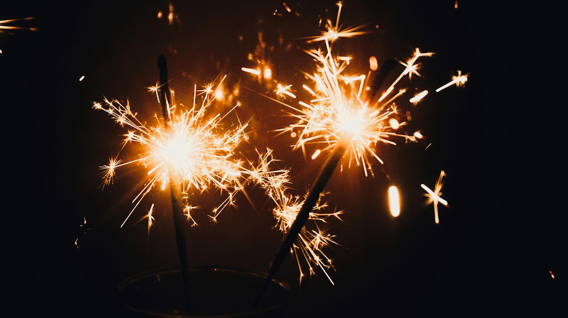 A vibrant close-up of sparklers illuminating the dark, perfect for festive occasions.