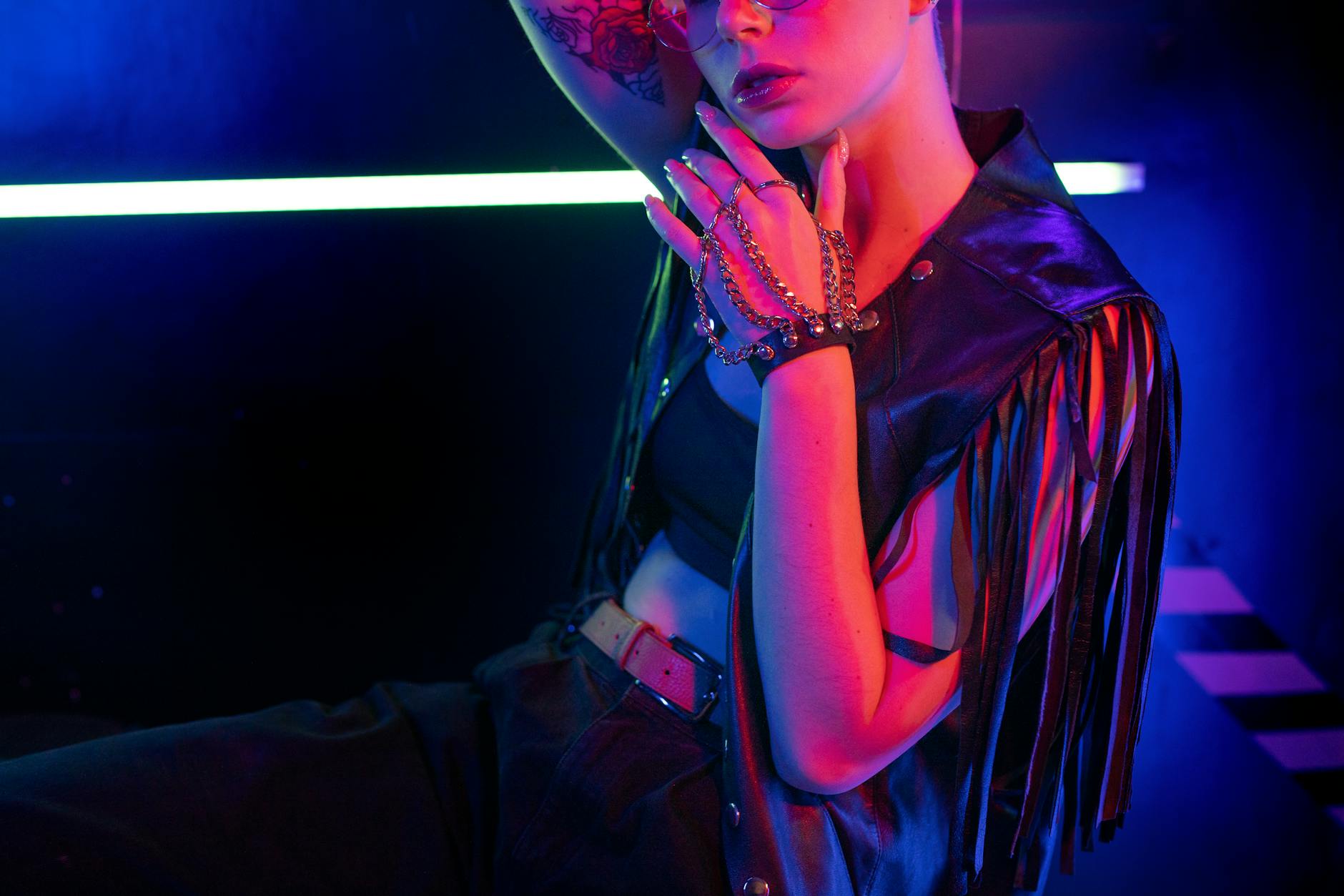 A bold fashion portrait featuring modern style and vibrant neon lighting.