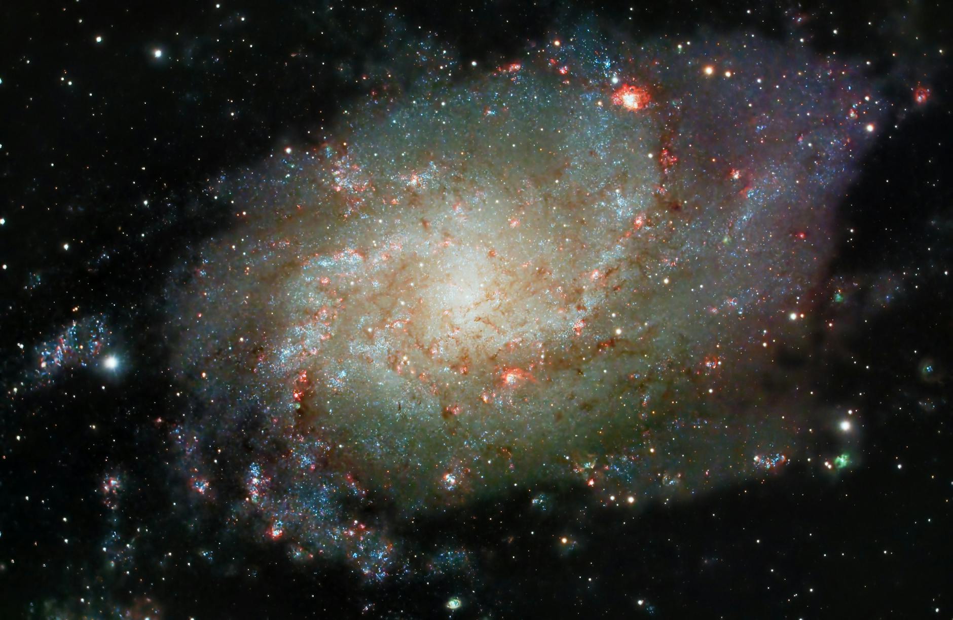 Explore the majestic spiral galaxy M33 with its vibrant cosmic colors, an astronomical wonder in the night sky.
